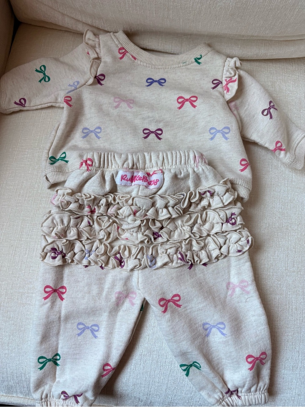 Ruffle Butts Cream Two-Piece Set with Pink, Purple, Green and Blue Bows